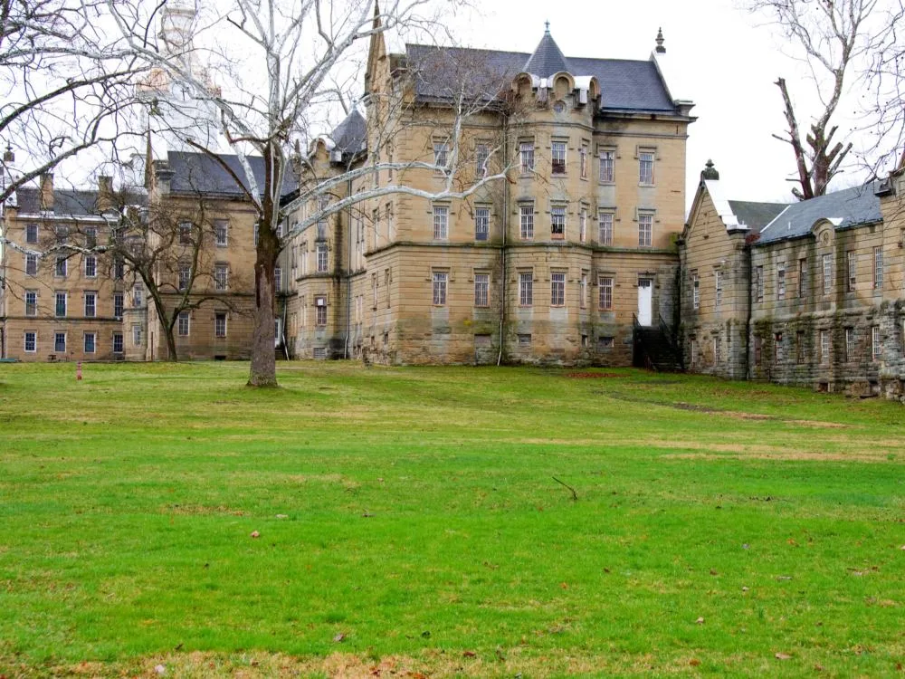 Trees on Fall standing beside the old buildings at the Trans-Allegheny Lunatic Asylum, one of the best attractions in West Virginia for paranormal enthusiasts 