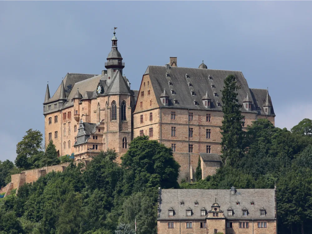 The large Castle of Marburg with a clock tower at its entrance, one of the best castles in Germany