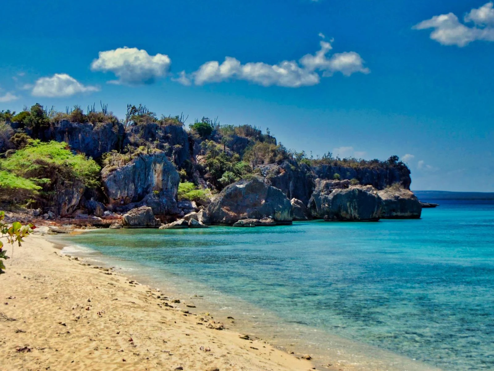 Huge rock formations standing on the tranquil waters of Bahía de Las Aguilas in Pedernales, one of the best beaches in the Dominican Republic