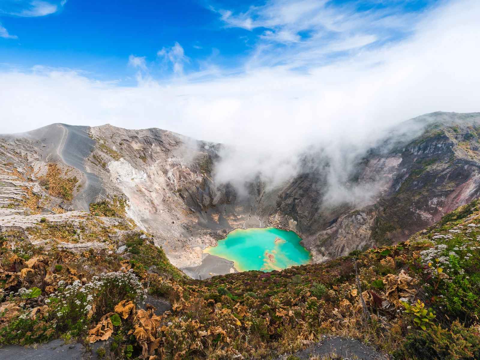 Irazu Volcano with steam over the water and teal water, one of the best places to visit in Costa Rica