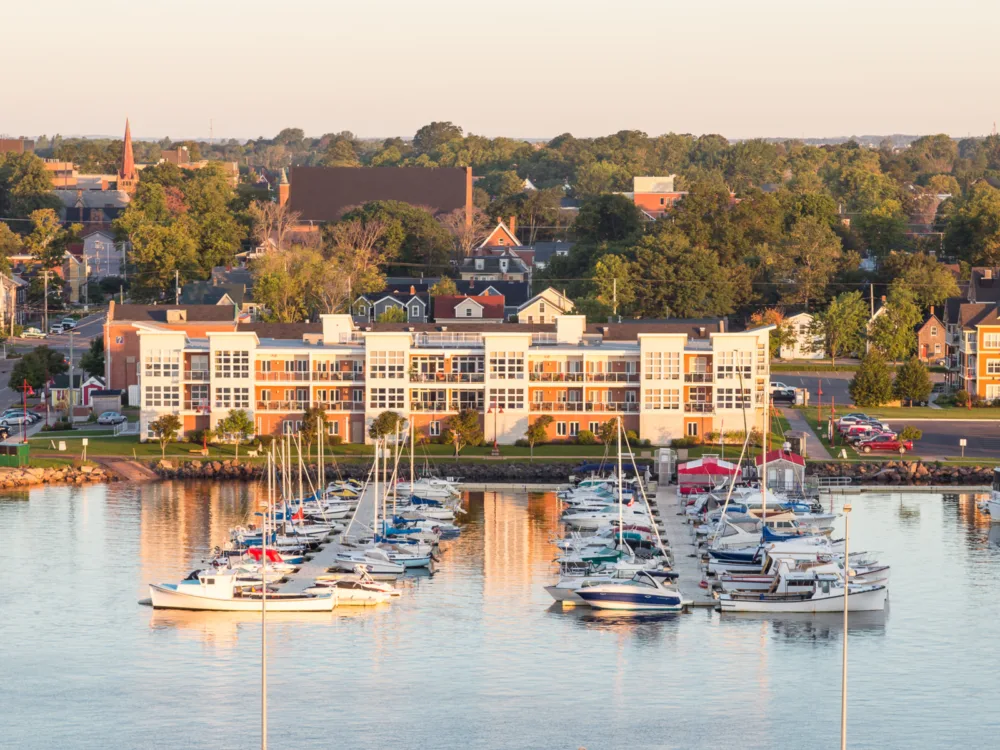 A scene in one of the best places to visit in Canada, several fishing boats neatly docked in a harbor of Charlottetown, Prince Edward Island