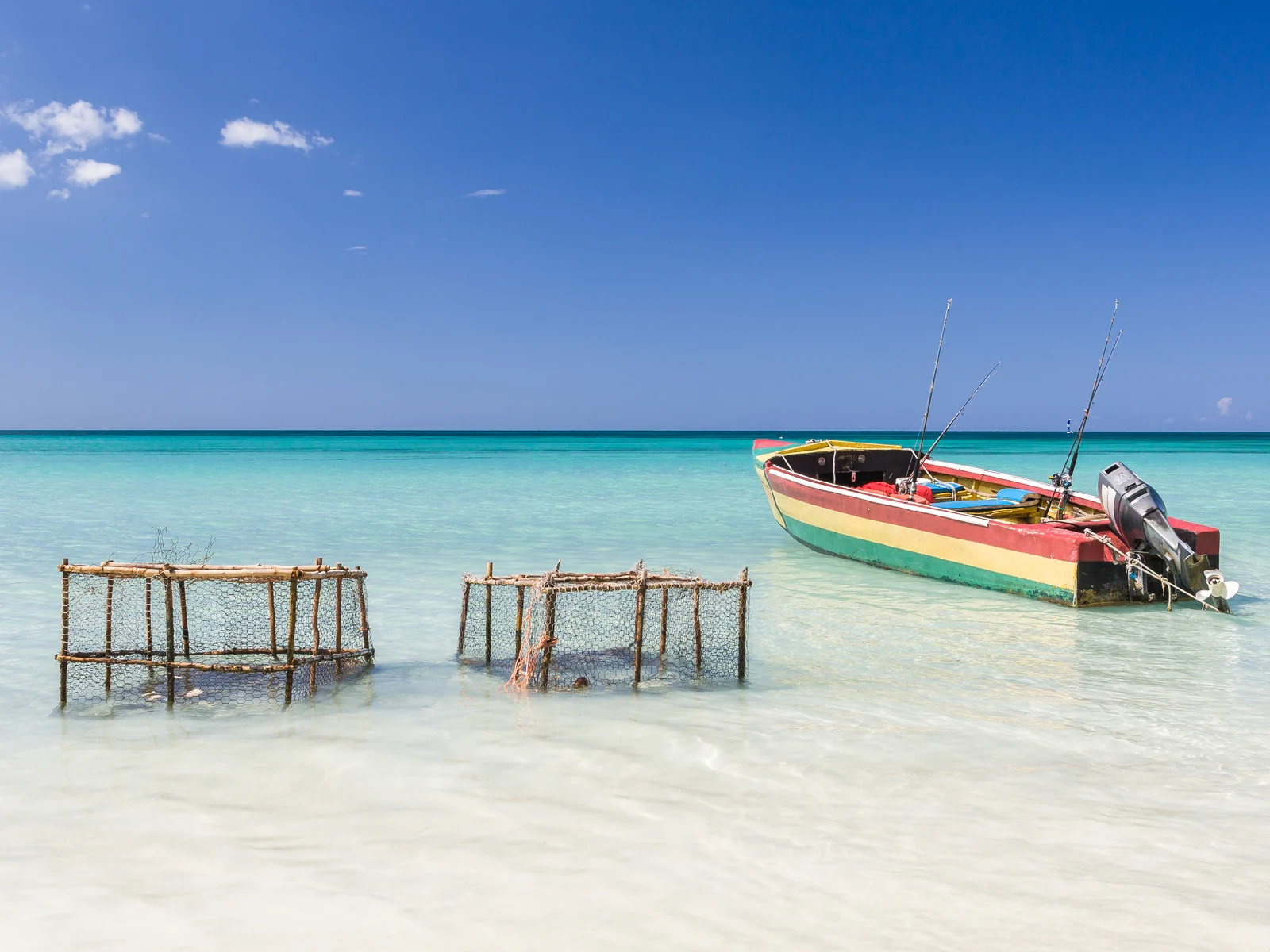 Neat view of Bloody Bay Beach, one of the best beaches in Jamaica, with lobster pots and a boat on the water