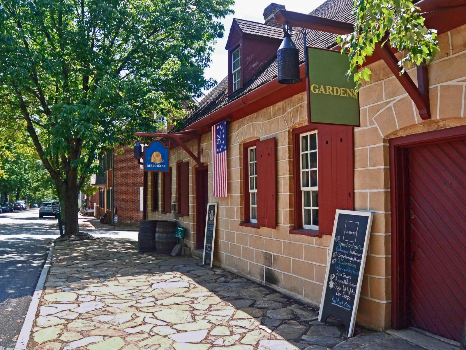 Neat view of one of the best places to visit in North Carolina, Old Salem, featuring a stone walking path next to an old colonial style house