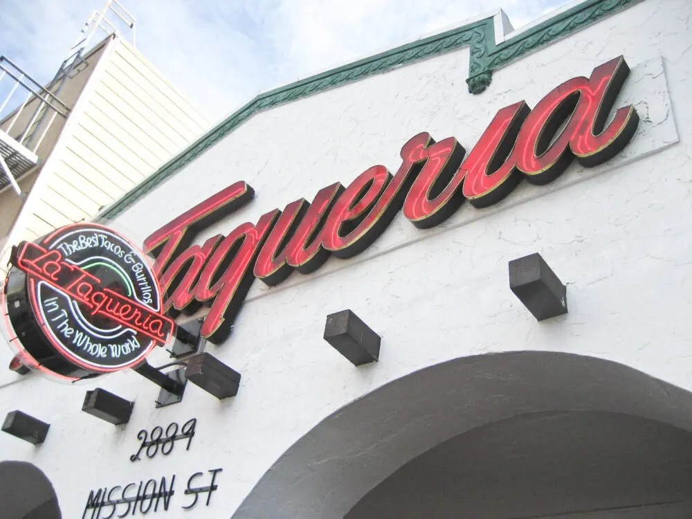 The huge red sign of La Taqueria, serving the best tacos and one of the best places to visit in San Francisco