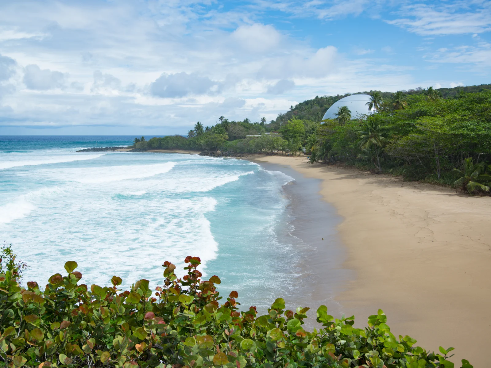 Domes beach in Playa Rincon, one of the best beaches in Puerto Rico, pictured on a cloudy day