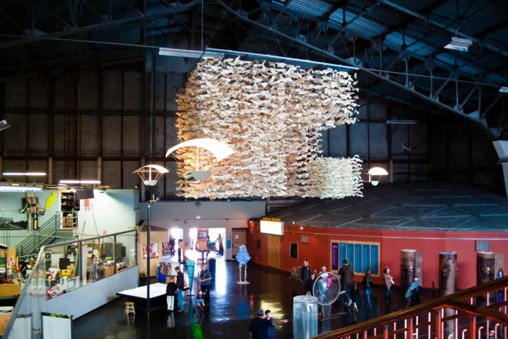 Multiple exhibits inside The Exploratorium, one of the best places to visit in San Francisco, where parents and kids enjoy viewing them