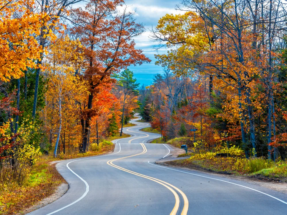 Empty winding road at Autumn in Door County as one of the best Wisconsin tourist attractions